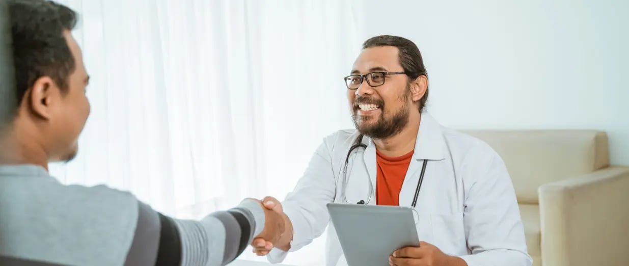 A man shaking hands with a doctor