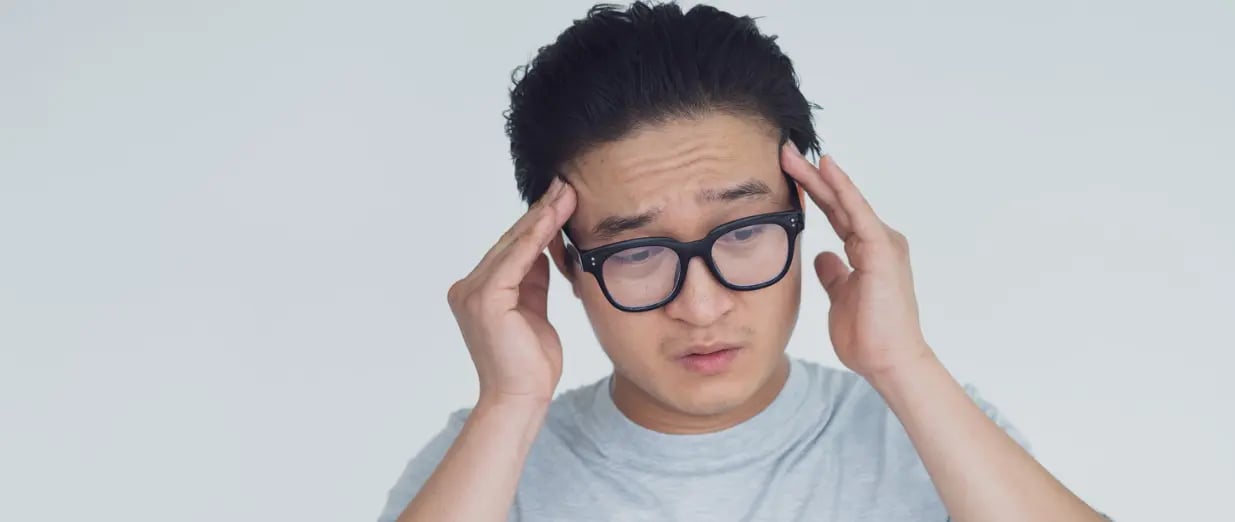 A man holding his head in dizziness