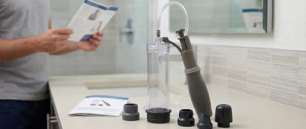 A man reading instructions for a vacuum erection device