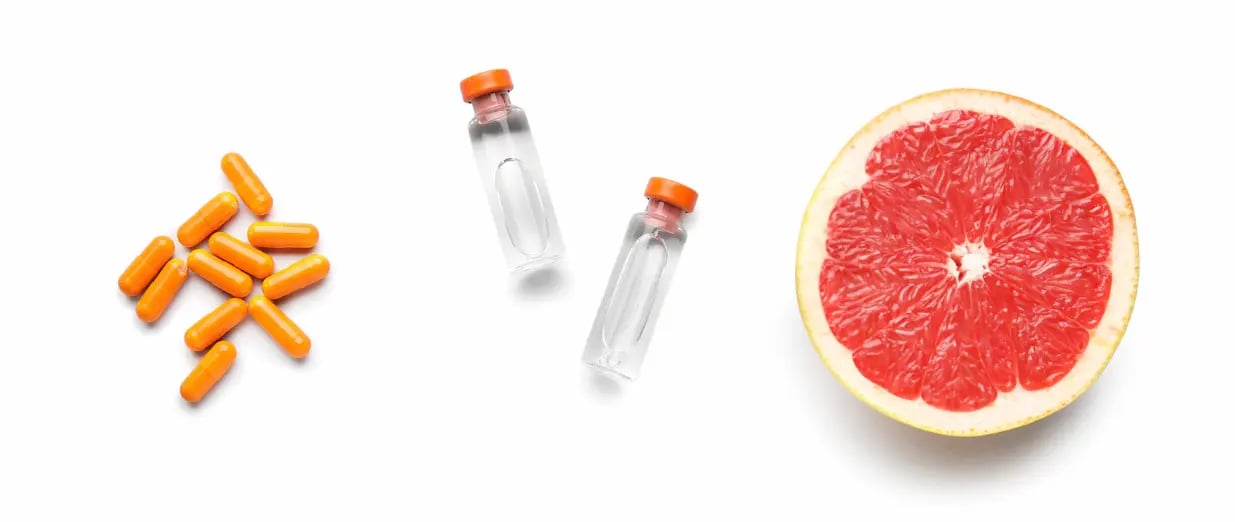 Capsules, medicine vials, and grapefruit slice