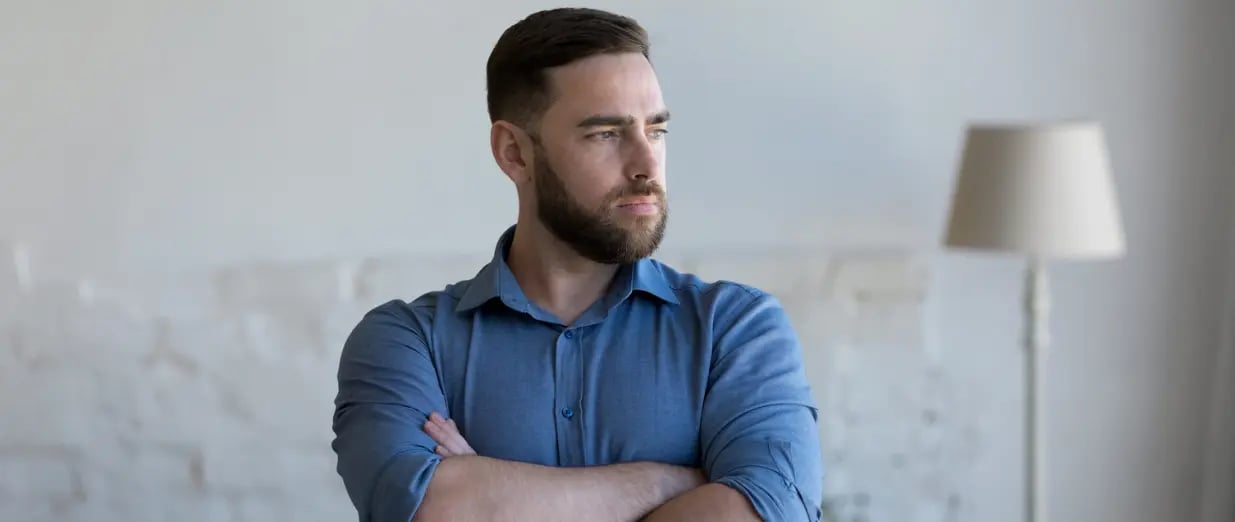 Man with crossed arms looking to the side
