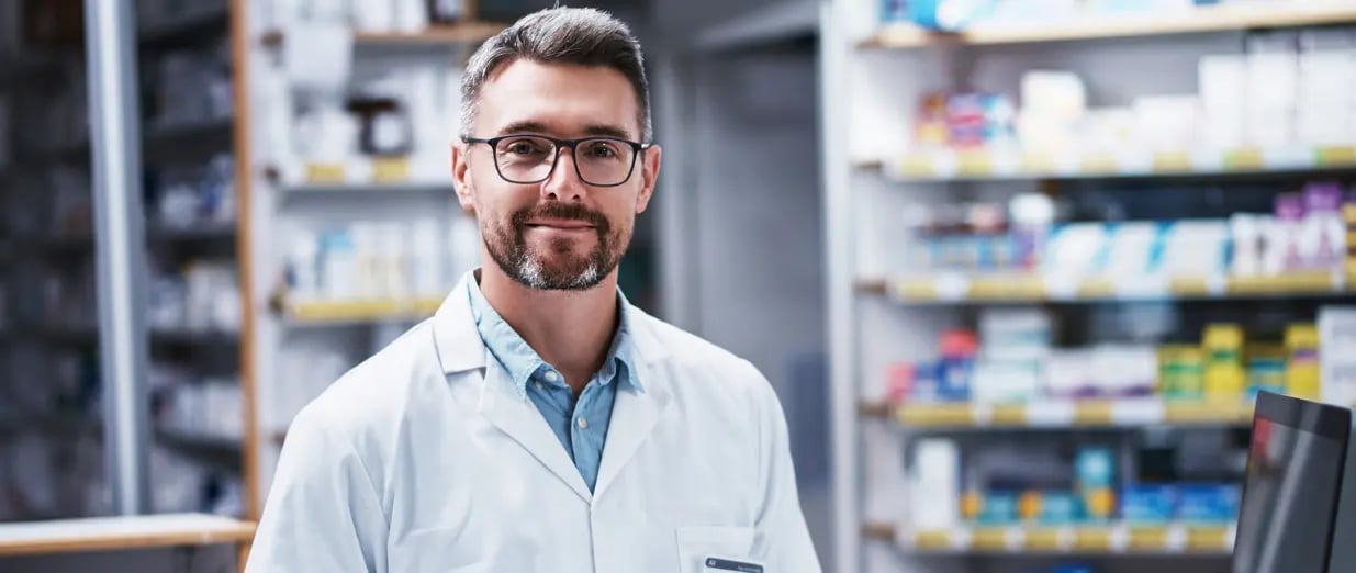 Pharmacist standing in a modern pharmacy interior