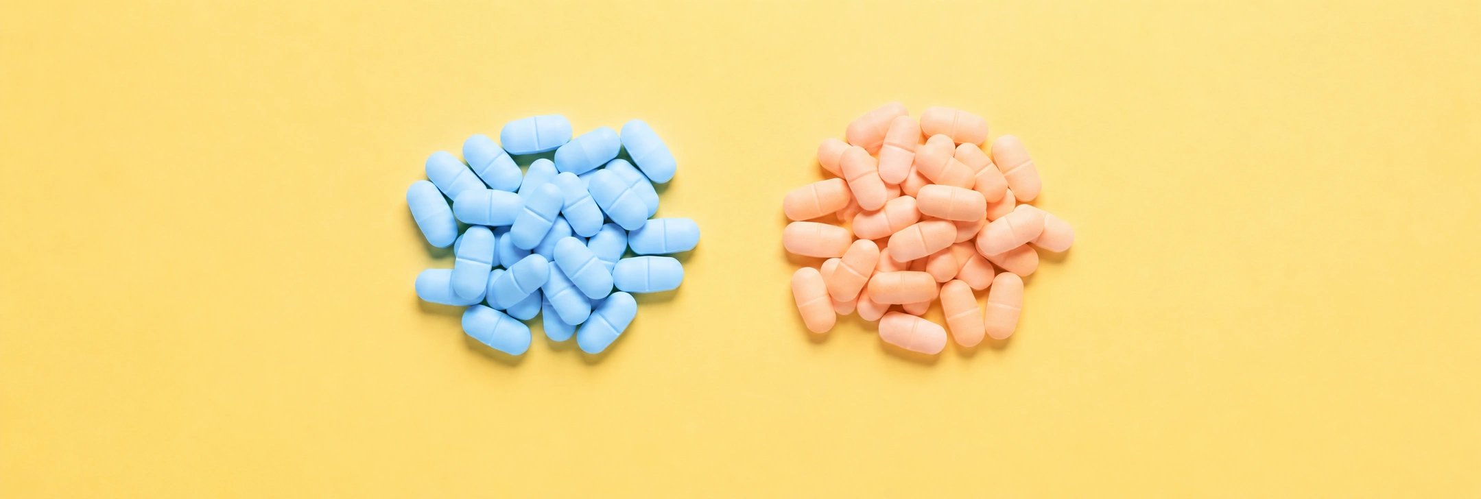 Blaue und orangefarbene Tabletten auf gelbem Hintergrund