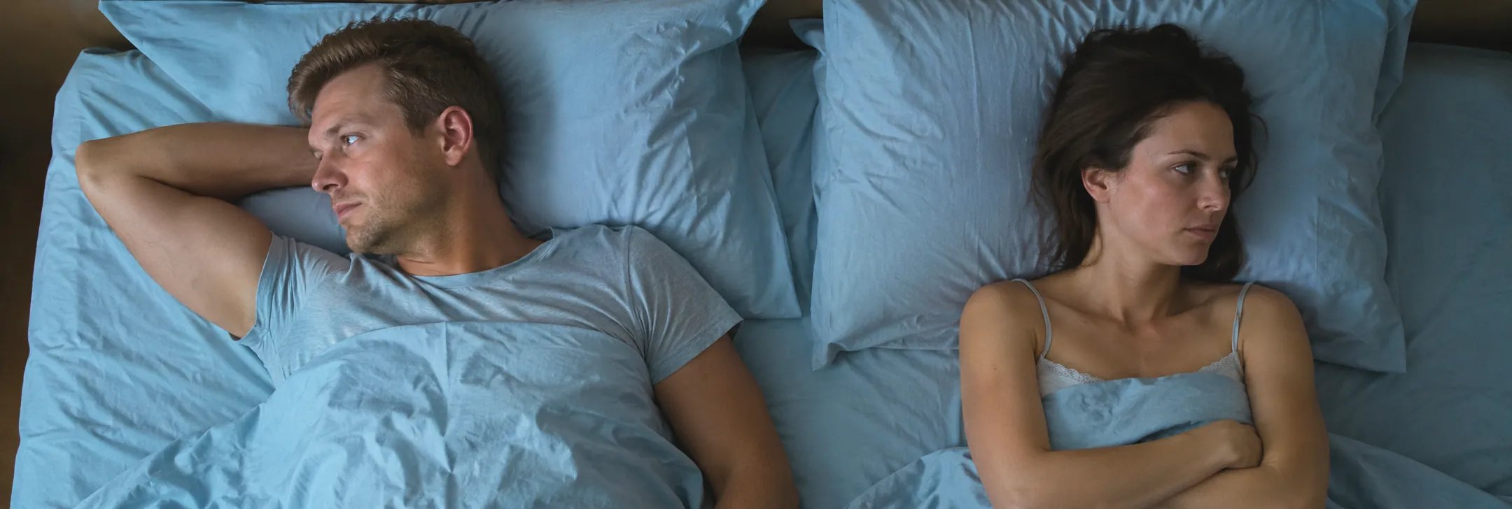 Young man and young woman with sexual problems in bed