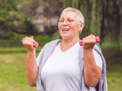 Eine ältere Frau bei Übungen zum Abnehmen an der frischen Luft