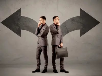 Two men standing back to back, thinking, with arrows pointing in opposite directions